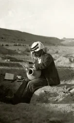 John Garstang at Jericho studying a Middle Bronze Age jug from c.1800 BC